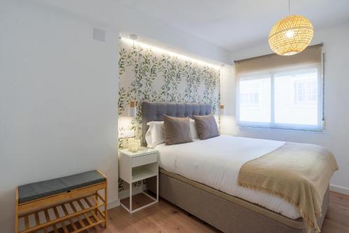 a bedroom with a large bed and a window at La Cala Beach by ELE Apartments in Cala del Moral