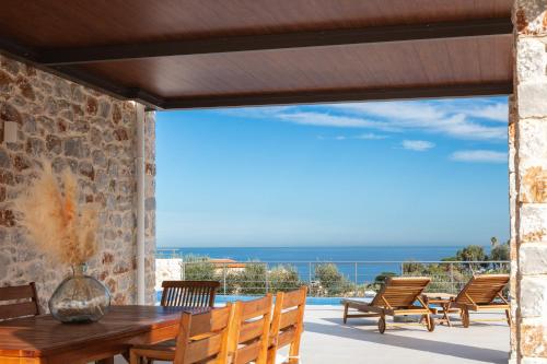 a view of the ocean from the patio of a house at Oinolithos Luxury Villas in Kalamaki