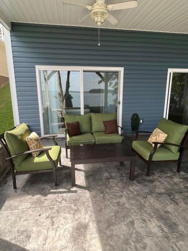 a patio with two chairs and a couch and a table at House #41 Moonset Vista House (Pet Friendly) in Centre