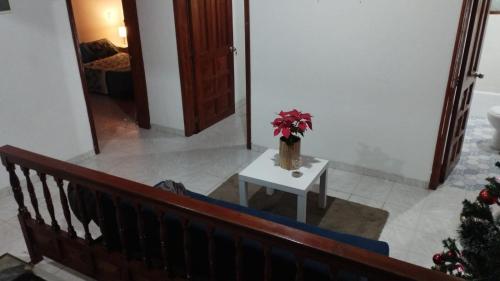 a stairway with a vase of flowers on a table at Mammamia CasaHotel in Duitama