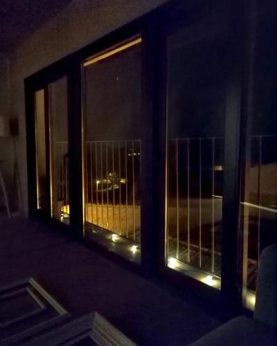 a window with a view of a city at night at Cal Cintet in Vilanova de Meyá