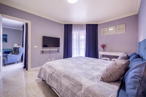 a bedroom with a bed and a television in it at Sailor Rest en Costa Sol in Costa Del Silencio