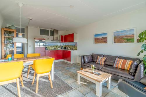 a living room with a couch and a table at Appartementencomplex Juliana 142 in De Koog
