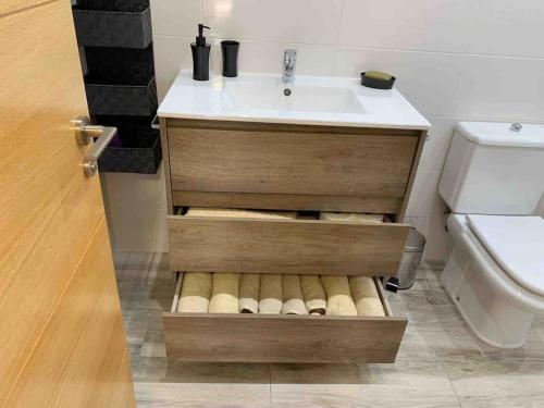 a bathroom with a sink and a toilet at Apartamento con jardín in Santander