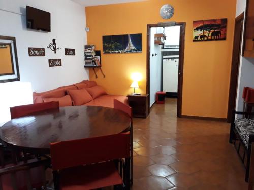 a living room with a table and a couch at Drumond Paradise in San Bernardo