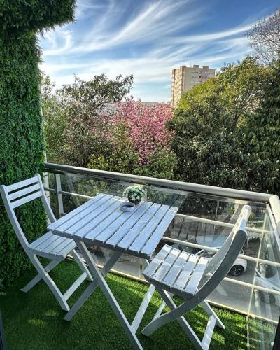 a blue picnic table and a chair on a balcony at Modern Private Suite with Balcony & Bathroom - King and Queen Beds in Vila Nova de Gaia