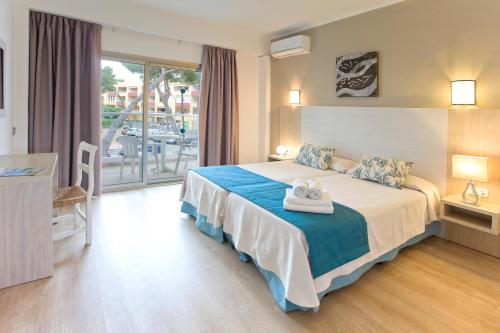 Ένα ή περισσότερα κρεβάτια σε δωμάτιο στο Petit Garden Hotel by Flacalco