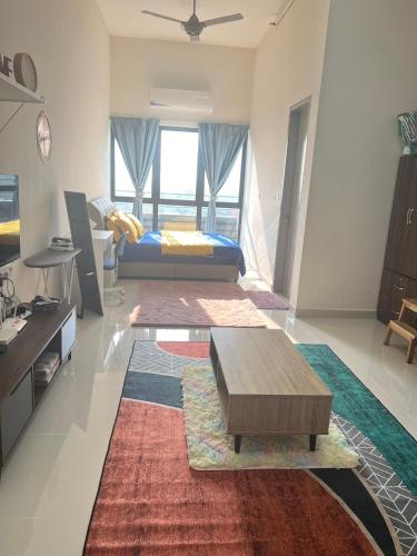 a living room with a bed and a coffee table at Yuyu Star Suites in Kampong Bekoh