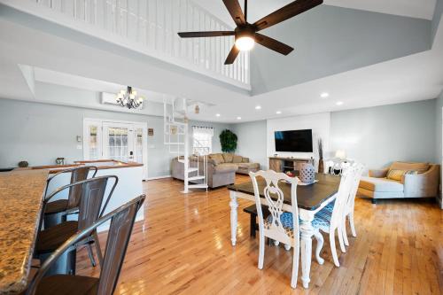 a dining room and living room with a ceiling fan at Cozy Blue Lake House in Williamstown
