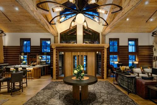 a lobby of a restaurant with a large chandelier at Teton Mountain Lodge and Spa, a Noble House Resort in Teton Village