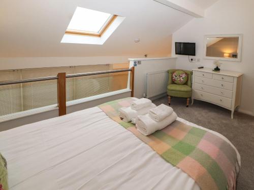 a bedroom with a large bed with two towels on it at Lark Meadow in Carnforth