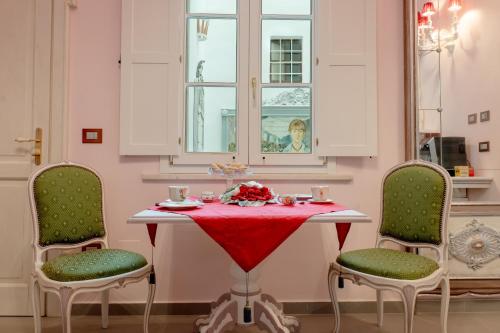 a table with a red table cloth and two chairs at The Crown Palace - Gallipoli in Gallipoli