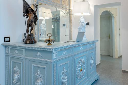 a blue dresser with a mirror on top of it at The Crown Palace - Gallipoli in Gallipoli