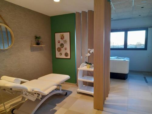 a hospital room with a hospital bed and a window at DOMITYS L'ALLIACEE - Résidence Services Séniors in Achères