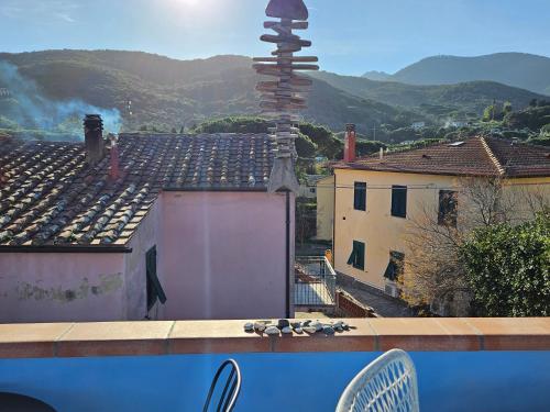 a balcony with a view of a city with mountains at VILLA VILLACOLLE in Procchio