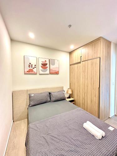a bedroom with a bed and a wooden cabinet at The Song Boutique Apartment in Vung Tau