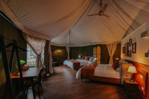 a bedroom with two beds in a tent at kMah@SomerMansion in Tanah Rata