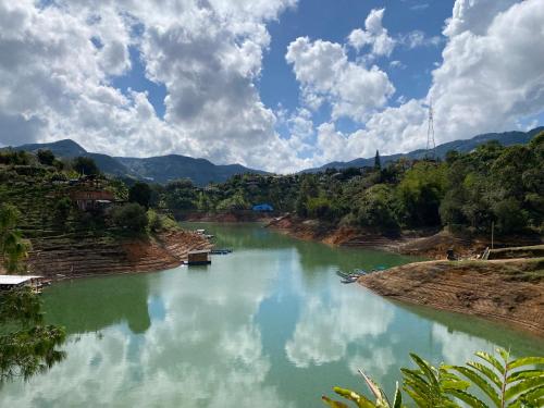 a view of a river with mountains in the background at Springfield Ecoloft- Guatapé in Guatapé