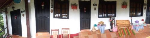 a model of a house with people standing outside of it at HOTEL CAMPESTRE ABRAZO DEL ANGEL in Aratoca