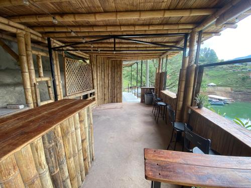 a building with a bar and some tables and chairs at Springfield Ecoloft- Guatapé in Guatapé