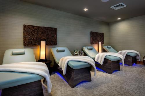 a waiting room with four blue chairs and a row of tables at Teton Mountain Lodge and Spa, a Noble House Resort in Teton Village