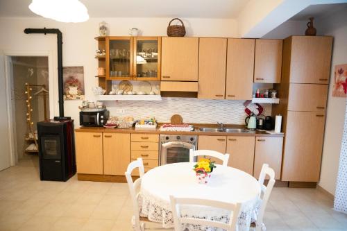 a kitchen with a table and a white table and chairs at B&B Flower House in Fasano