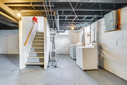 a room with stairs in a kitchen with a broom at Beautiful Berkley Home about 18 Mi to Downtown Detroit in Berkley