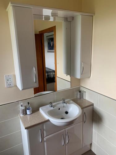 a bathroom with a sink and a mirror at Polrudden in Orkney