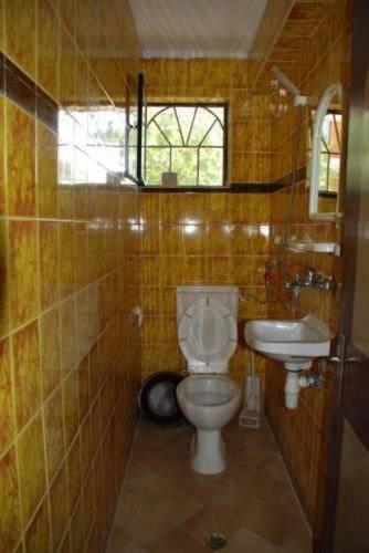 a bathroom with a toilet and a sink at Guest House Rusalka in Byala