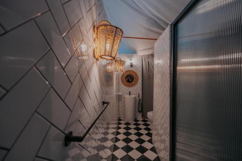 a bathroom with a toilet and a checkered floor at kMah@Parkland in Brinchang