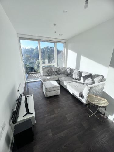 a living room with a couch and a table at Private Flat in London in London