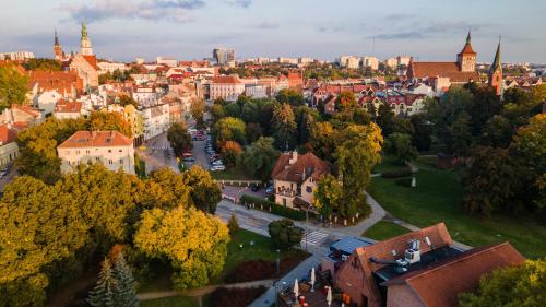 z góry widok na miasto z drzewami i budynkami w obiekcie Hotel Pod Zamkiem w Olsztynie