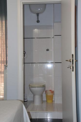 a bathroom with a white toilet in a room at Villa Axa in Casal Palocco