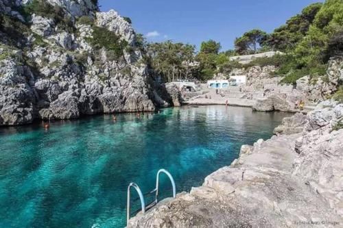 a pool of blue water in a river with rocks at LA PERLA, comfort e relax in Vignacastrisi
