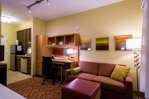 a living room with a couch and a desk with a computer at TownePlace Suites by Marriott Roswell in Roswell