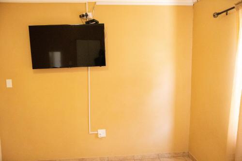 Elle comprend une télévision à écran plat suspendue au mur. dans l'établissement Josef Self Catering, à Swakopmund
