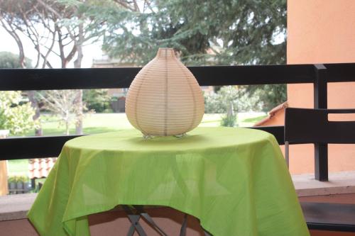 a vase sitting on top of a green table at Villa Axa in Casal Palocco