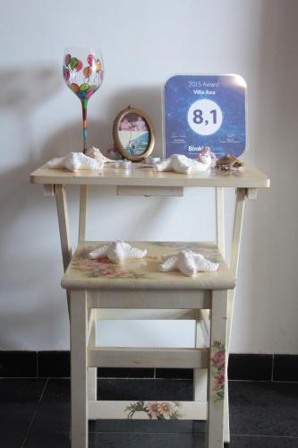 a table with a clock on top of it at Villa Axa in Casal Palocco