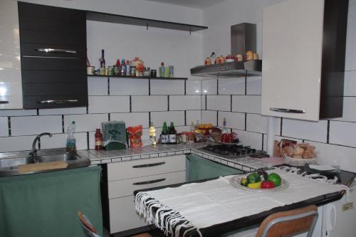 a kitchen with a table with a bowl of fruit on it at Villa Axa in Casal Palocco