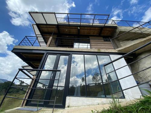 a house with a balcony on top of it at Springfield Ecoloft- Guatapé in Guatapé