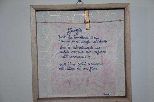a writing on a white board in a frame at Villa Axa in Casal Palocco