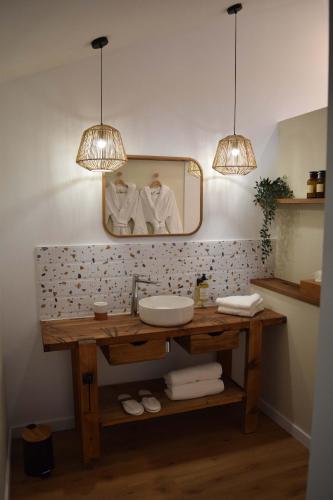 a bathroom with a sink and a mirror at Le Chai in Nissan-lez-Enserune