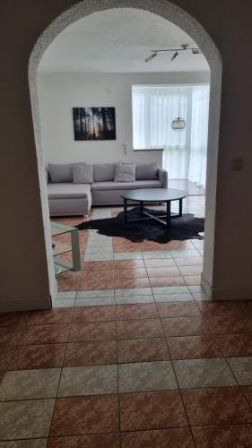 a living room with a couch and a table at Wohnen auf Zeit - perfekt für Grenzgänger, Wochenend-Heimkehrer und Berufsreisende in Schwörstadt