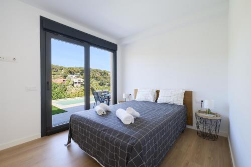 a bedroom with a bed and a large window at 2Agnes01 in Vidreres