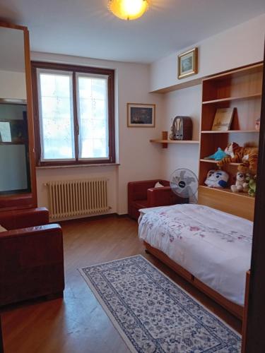1 dormitorio con cama y ventana en Villa Azalea, en San Fermo della Battaglia