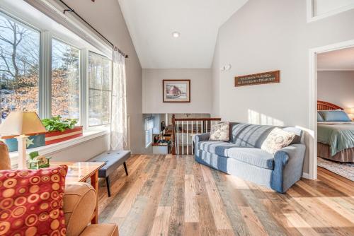a living room with a couch and a table at Quiet New Hampshire Getaway with Game Room! in Center Barnstead