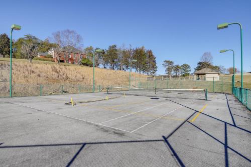 a tennis court with two tennis rackets on it at Large Tazewell Home Less Than 1 Mi to Norris Lake Access! in Tazewell
