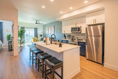 a kitchen with a large island with bar stools at Shopping & Dining Dist-Resort Pool-Views-King Bed S439 in Scottsdale