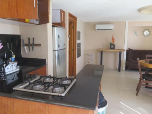 a kitchen with a stove top oven in a kitchen at Suites Atlas - Ocean Front in Bucerías