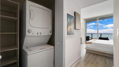 a kitchen with a washer and dryer in a room at 2 bed rental on the beach15th floor Hollywood Miami in Hallandale Beach